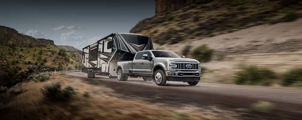 Silver Ford Super Duty hauling a camper