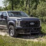 Grey 2025 Ford F-250 driving on a trail