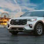 Silver 2026 Ford Explorer parked on a dock by the water