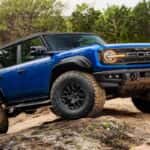 Blue Ford Bronco Raptor on a trail