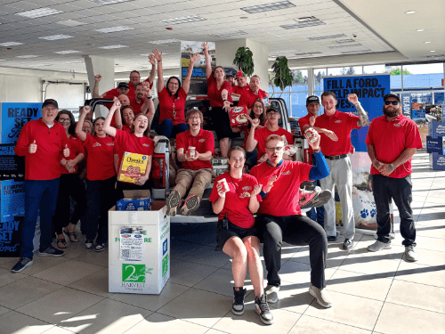 A group of people in red shirts posing for a photo