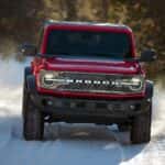 Red Ford Bronco Driving Through the Snow