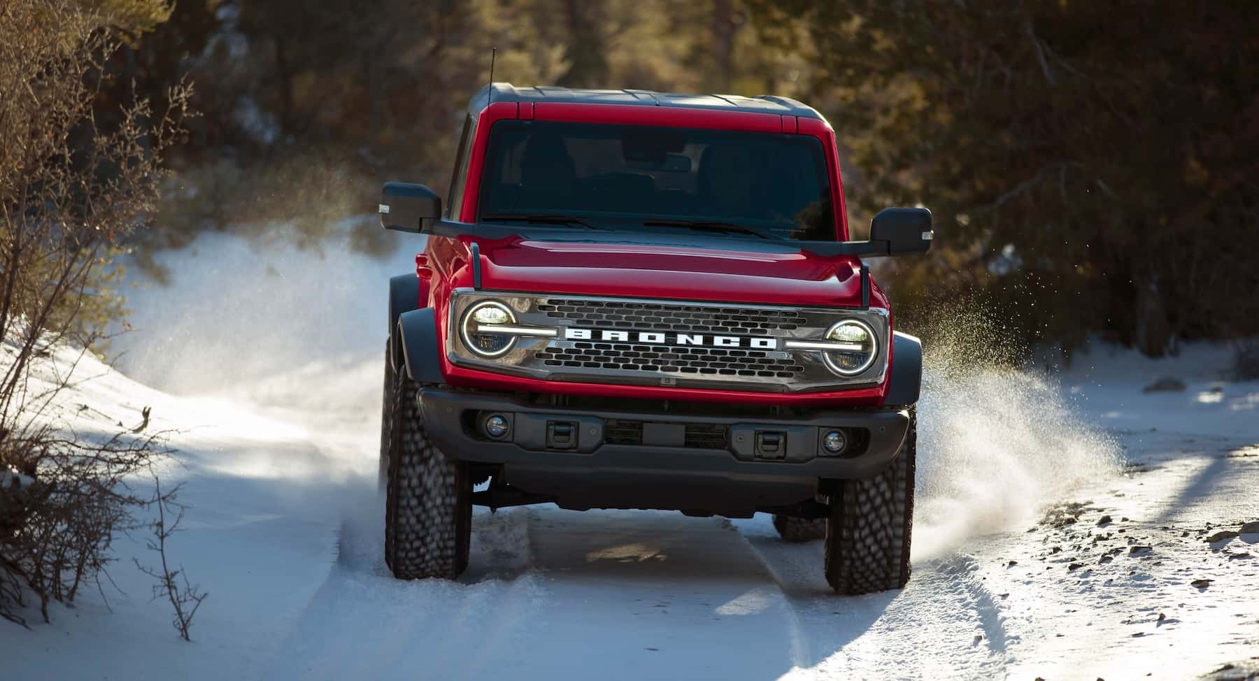 Red Ford Bronco Driving Through the Snow