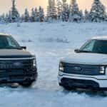 Two Ford F-150 trucks parked in the snow