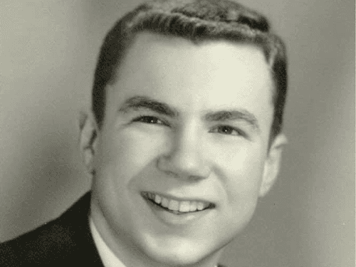 A 1961 portrait of Dick Wendle smiling, marking the year he began working full-time at Wendle Ford.