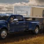 Blue Ford Super Duty truck towing a horse trailer