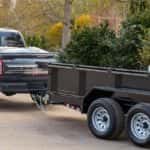 Ford F-150 towing a trailer with landscape supplies