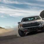 Silver Ford truck off roading in the desert