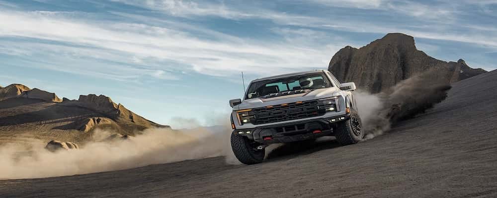 Silver Ford truck off roading in the desert