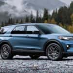 Blue Ford Explorer parked by a river