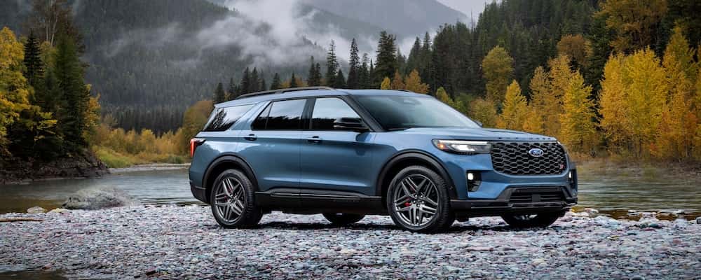 Blue Ford Explorer parked by a river