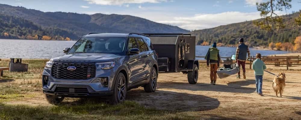 Ford Explorer towing a camper on a lake trip