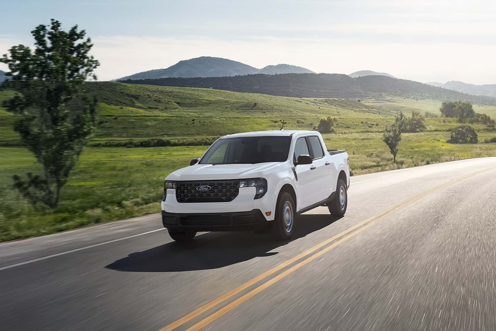 2026 Ford Maverick driving down a scenic road