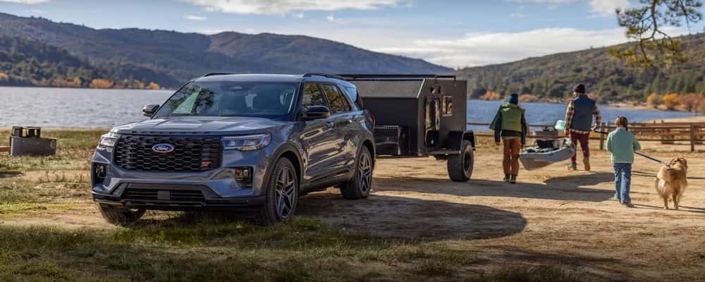 Ford Explorer towing a trailer by the lake
