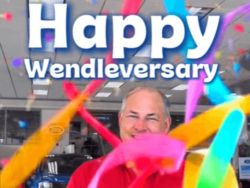 Happy Wendleversary celebration graphic featuring Andy smiling amidst colorful floating streamers and confetti.