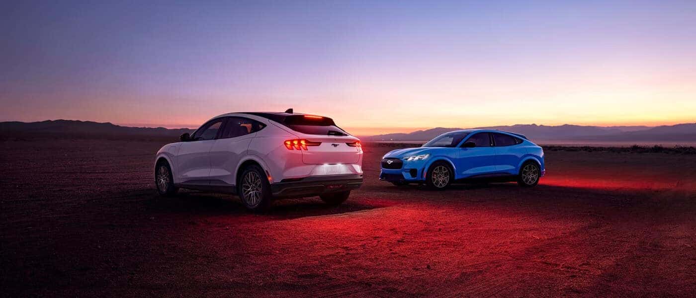 2026 Ford Mustang Mach-E pair parked in desert at dusk