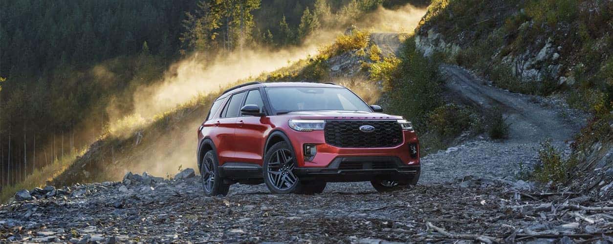 Red 2025 Ford Explorer ST on a mountain trail in red