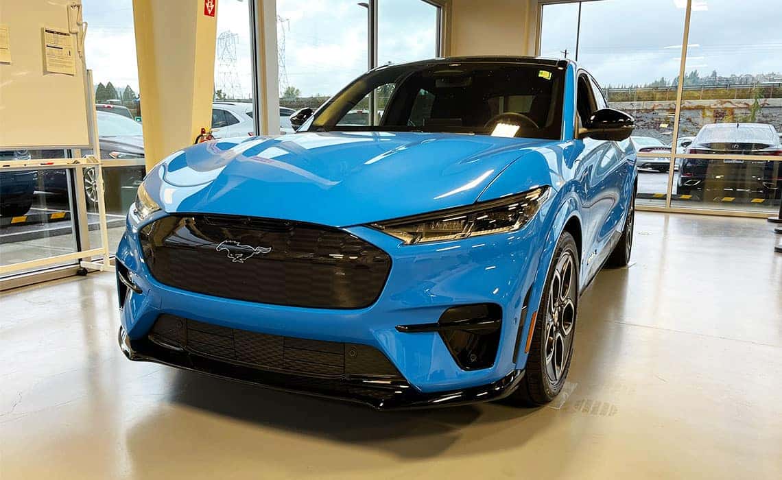 2023 Mustang Mach-E GT in blue parked in the showroom at Westlie Ford in Washougal, WA