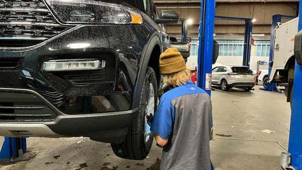 Mechanics working on Ford vehicles