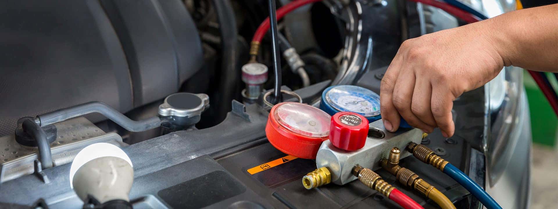 technician checking air conditioner in car