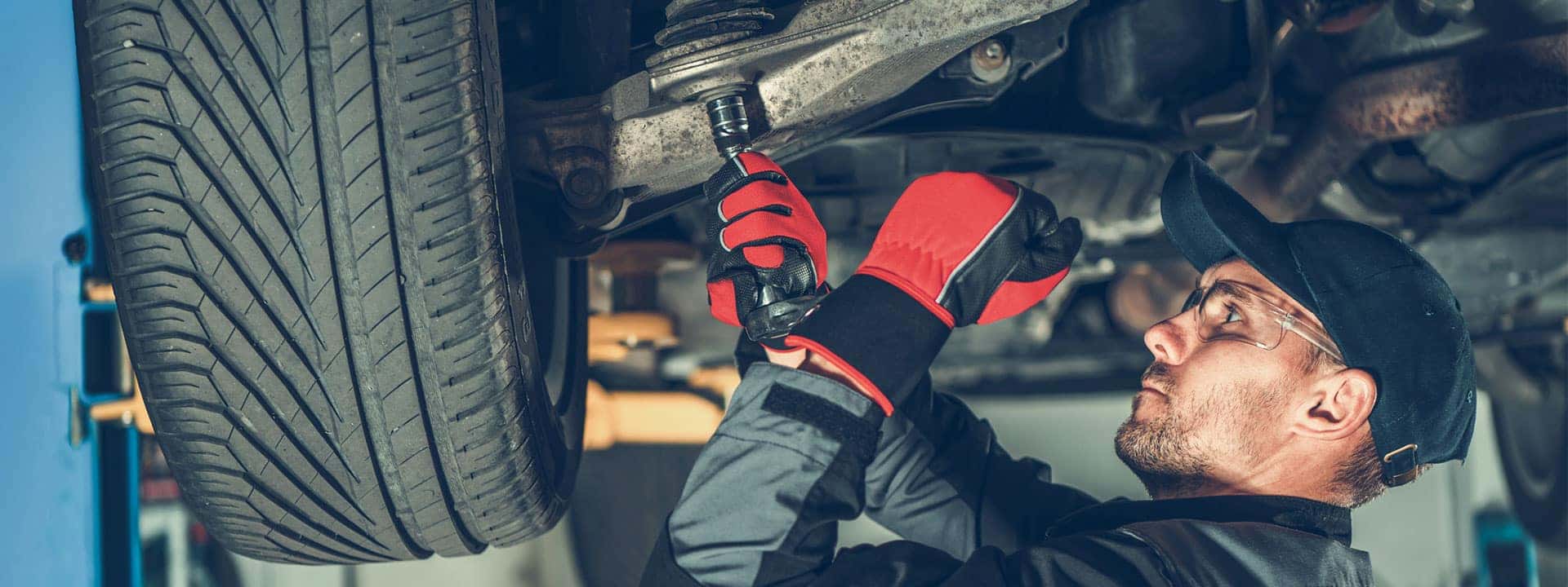 Technician servicing the suspension of a car