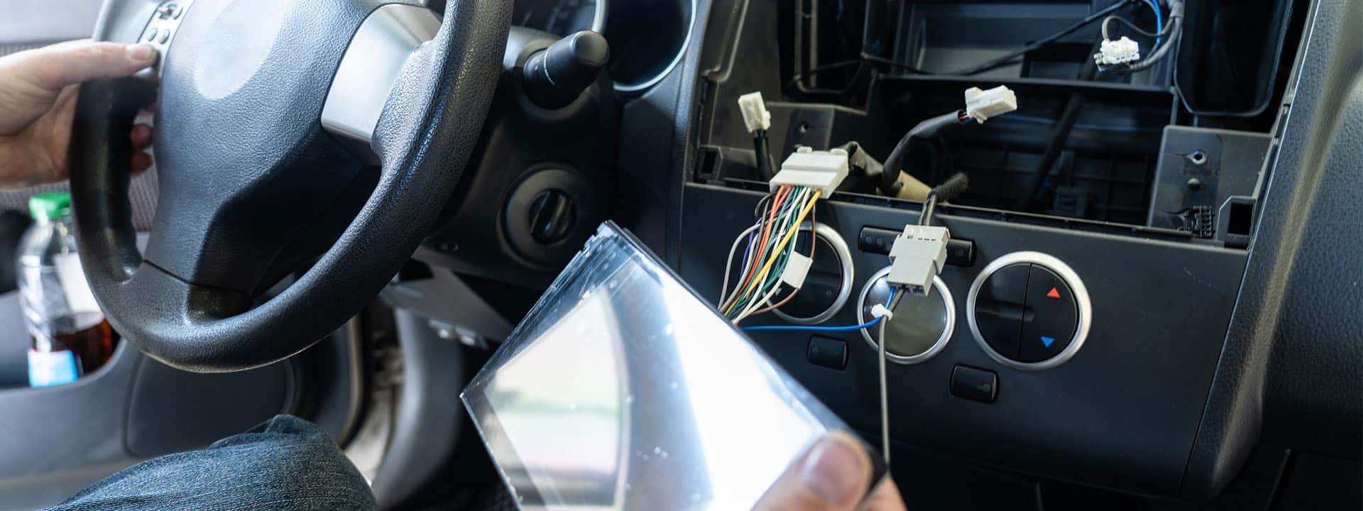 technician repairing the infotainment in a car cabin