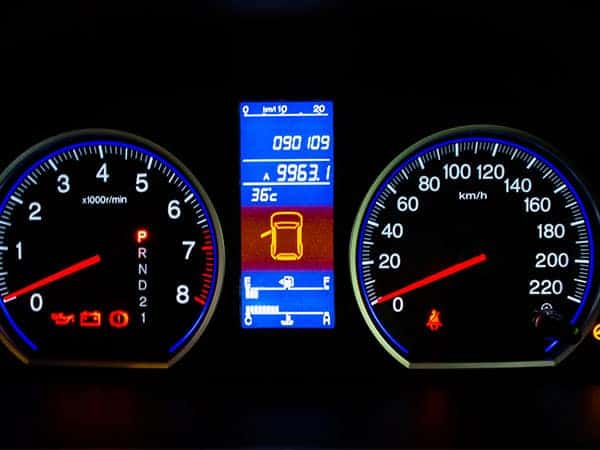 vehicle cluster showing odometer and warning lights on a car