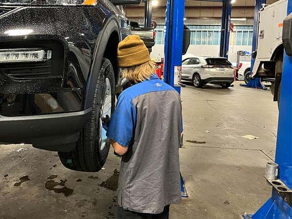 Ford technician servicing a tire on a Ford vehicle