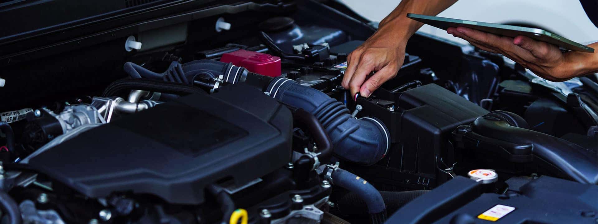 technician repairing the engine of a car
