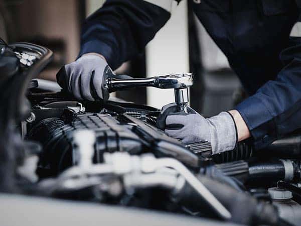 technician repairing the engine of a car, transmission service