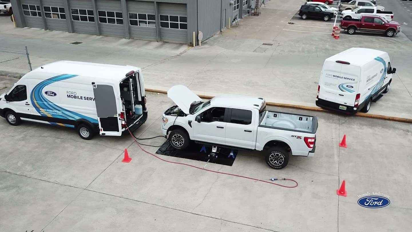 Aerial view of a Ford Mobile Service vehicle performing maintenance on a commercial job site