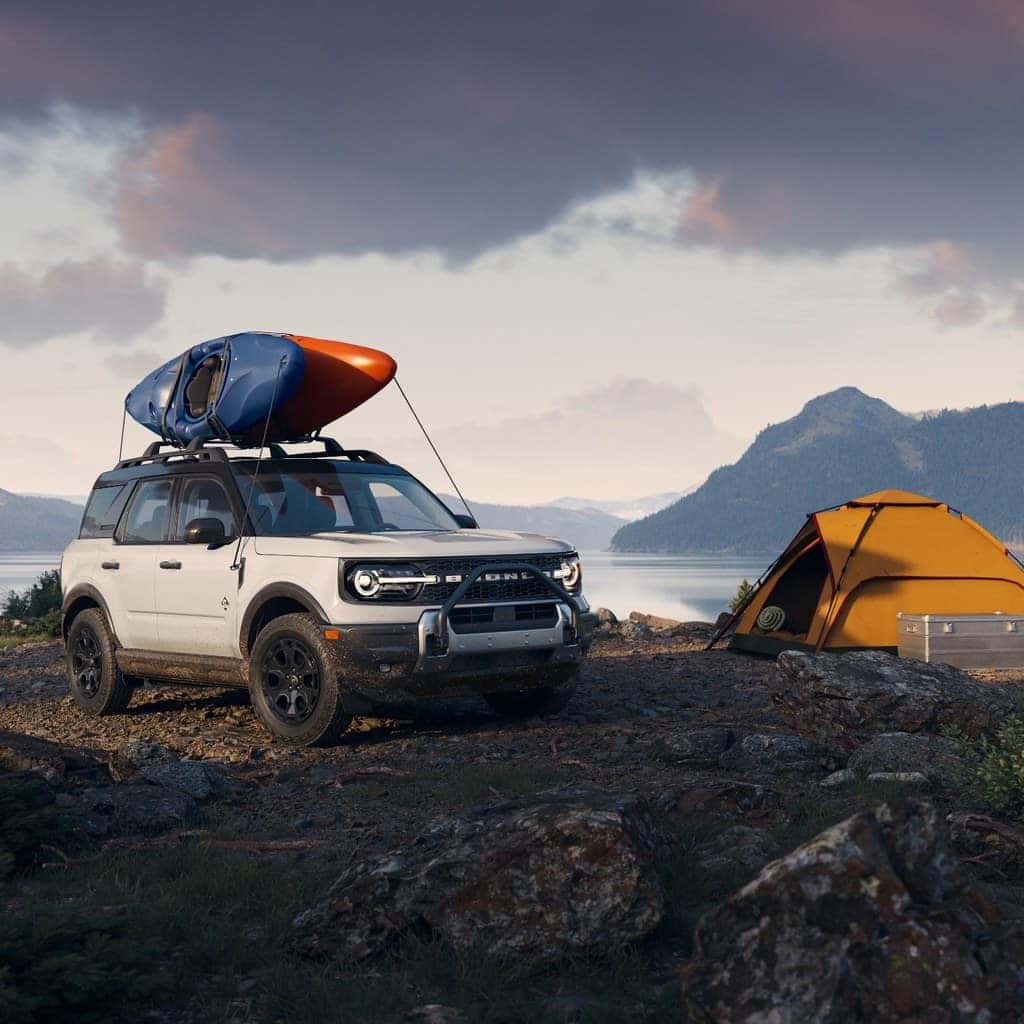 2026 Ford Bronco Sport with kayaks and camping gear near a mountain lake
