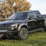 black ford parked on green grassy hill